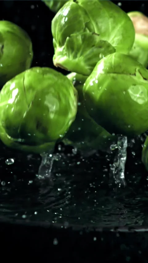 Brussel sprouts fall on a wet plate. Filmed on a high-speed camera at 1000 fps Stock Footage 335318095