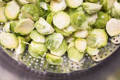 Brussel Sprouts in a steaming rack inside of a pot for cooking Stock Photos