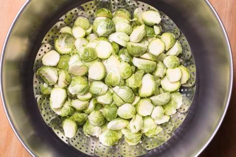 Brussel Sprouts in a steaming rack inside of a pot for cooking Stock Photos