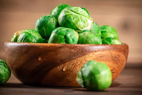 Brussels cabbage in a bowl on the table. Stock Photos