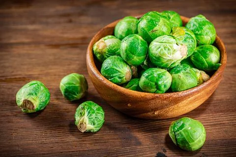 Brussels cabbage in a bowl on the table. Stock Photos
