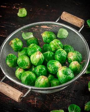 Brussels sprouts in a colander. Stock Photos