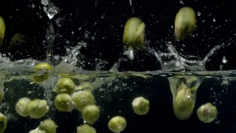 Brussels sprouts falling into the water with a splash and bubbles Stock Footage 123703908