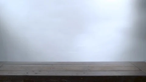 Brussels Sprouts falling on wooden surface in slow motion Stock Footage 100009284