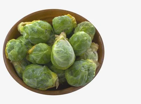 Brussels sprouts in rustic container on light background Stock Photos