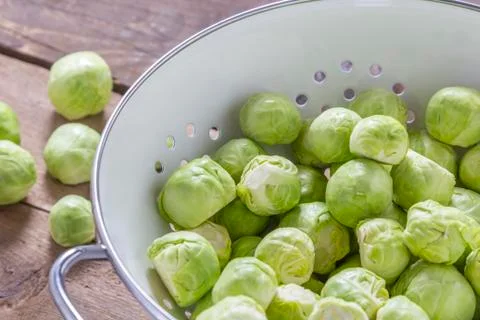 Brussels sprouts in a sieve on a table Stock Photos