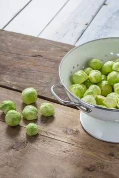 Brussels sprouts in a sieve on a table Stock Photos