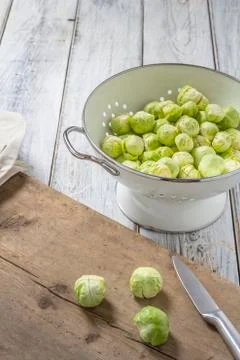 Brussels sprouts in a sieve on a table Stock Photos
