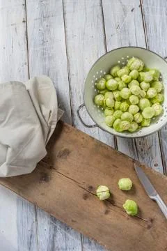 Brussels sprouts in a sieve on a table Stock Photos