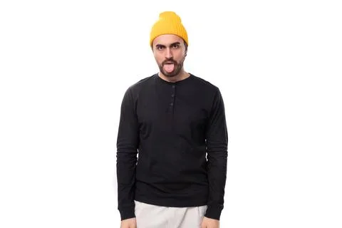 Brutal 30s authentic brunette male adult in black sweatshirt showing tongue on Stock Photos
