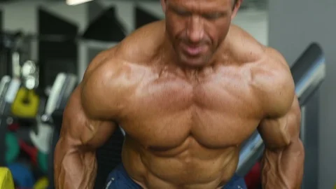 Brutal aged strong bodybuilder athletic men pumping up muscles with dumbbells Video stock 90967688