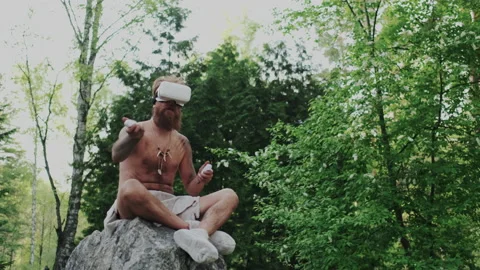 Brutal Ancient Human Using VR Glasses or Interactivity Innovate Headset. He Stock Footage 130906285