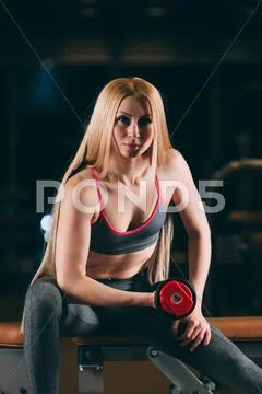 Premium Photo  Fitness woman pumping up muscles workout in gym