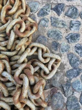 Brutal background with old boat chain on the cobbles Stock Photos