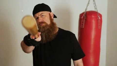 Brutal beard man with baseball bat looks bad at the camera. 스톡 동영상 107974710