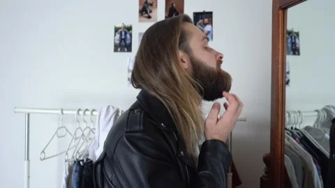 Brutal beard man in a Leather Jacket,  spraying perfume Stock Footage 147896415