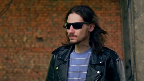 Brutal guy in a leather jacket in an old house Stock Footage 112247038