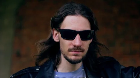 Brutal guy in a leather jacket in an old house Stock Footage 112247295