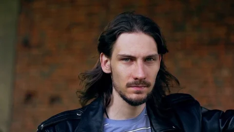 Brutal guy in a leather jacket in an old house Stock Footage 114261434