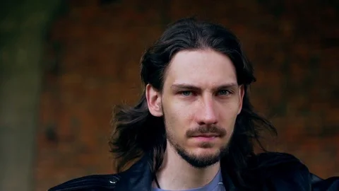 Brutal guy in a leather jacket in an old house Video stock 115564740