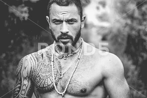 Brutal handsome man with tattooed body. Men tattoo casual fashion. Portrait of Stock Photos