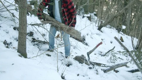 Brutal lumberjack walks through the winter forest Stock Footage 123525883