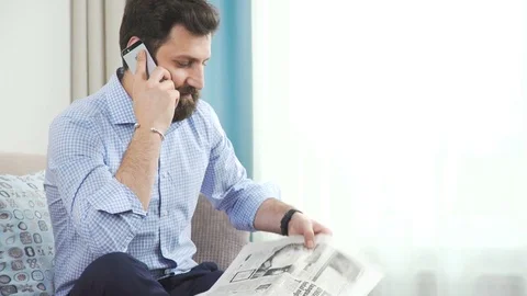 Brutal man with a beard makes a working phone call an re Stock Footage 76152906