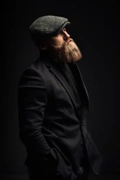 Brutal man in a hat with a beard Stock Photos