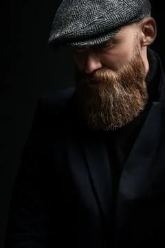Brutal man in a hat with a beard Stock Photos