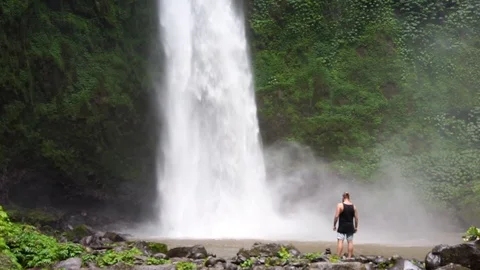 Brutal man looking to big waterfall. Green plants on background. Power of nature Stock Footage 110733392