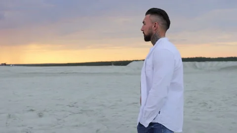 Brutal man walking on beach Stock Footage 201104714