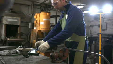 Brutal man in working clothes and apron saws circular electric Stock Footage 87467889