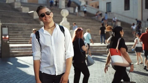 Brutal model man with sunglasses posing on square on the background of stairs Stock-Footage 113547097