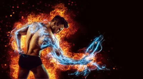 Brutal strong athletic Bodybuilder posing. Fire and spark explosion in the Stock Photos