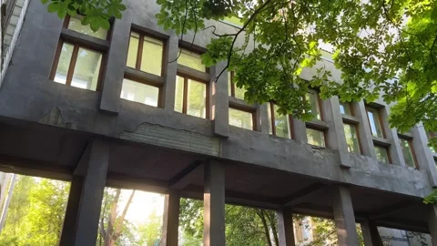 Brutalist Skybridge at Sunset: Sunbeams Through Arched Windows Frame 1960s Stock Footage 278014971