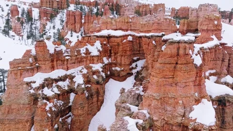 Bryce Canyon With Red Rocks Covered With Snow In Winter - aerial drone shot Stock Footage 251633679