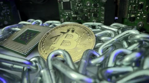 BTC on the table with silver chain as blockchain technology and CPU for mining Stock Footage 143824015
