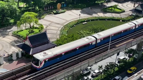 BTS elevated train backgrounded by Benchasiri park, Bangkok, Thailand 4K Stock Footage 204136066