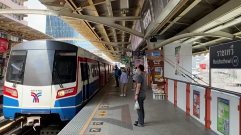 BTS Sky train arrives in Ratchathewi station, downtown Bangkok, Thailand 4K Stock Footage 236201785