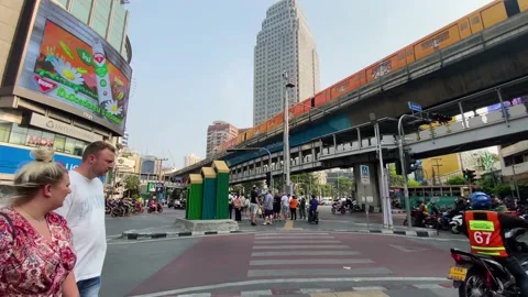 The BTS Sky train cross the Asok intersection in Bangkok, Thailand 4K Stock Footage 235926607