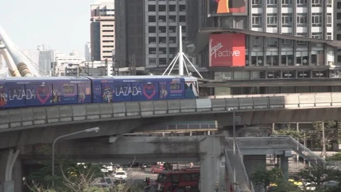 BTS sky train on rail above traffic in Bangkok, Thailand. Video stock 107066990