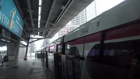 BTS Sky Train on rail tracks above traffic in city. Stock Footage 250415858