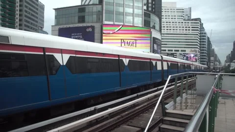BTS Sky Train on rail tracks above traffic in city. Stock Footage 250415912