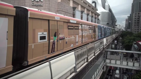 BTS Sky Train on rail tracks above traffic in city. Stock Footage 250415950