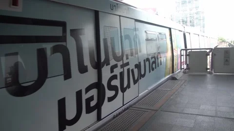 BTS Sky Train on rail tracks above traffic in city. Stock Footage 250417967