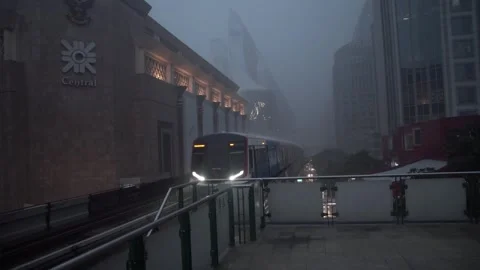 BTS skytrain above busy traffic during heavy rain. Stock Footage 252258137