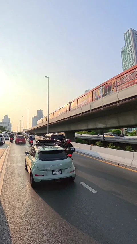 BTS Skytrain Above Heavy Traffic in Bangkok, Thailand Stock Footage 344603987
