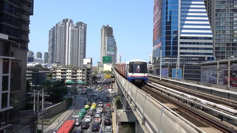 BTS Skytrain in Bangkok, passing train in the background of the city. Stock Footage 128688375