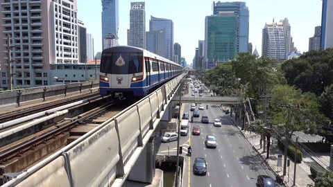 BTS Skytrain in Bangkok, passing train in the background of the city. Stock Footage 128689156