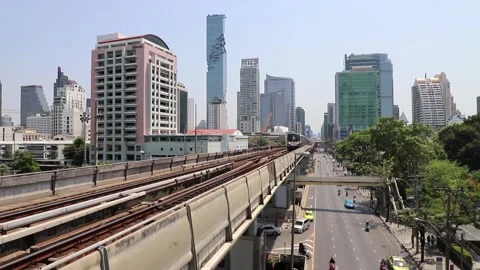 BTS Skytrain in Bangkok, passing train in the background of the city. Stock Footage 130181522